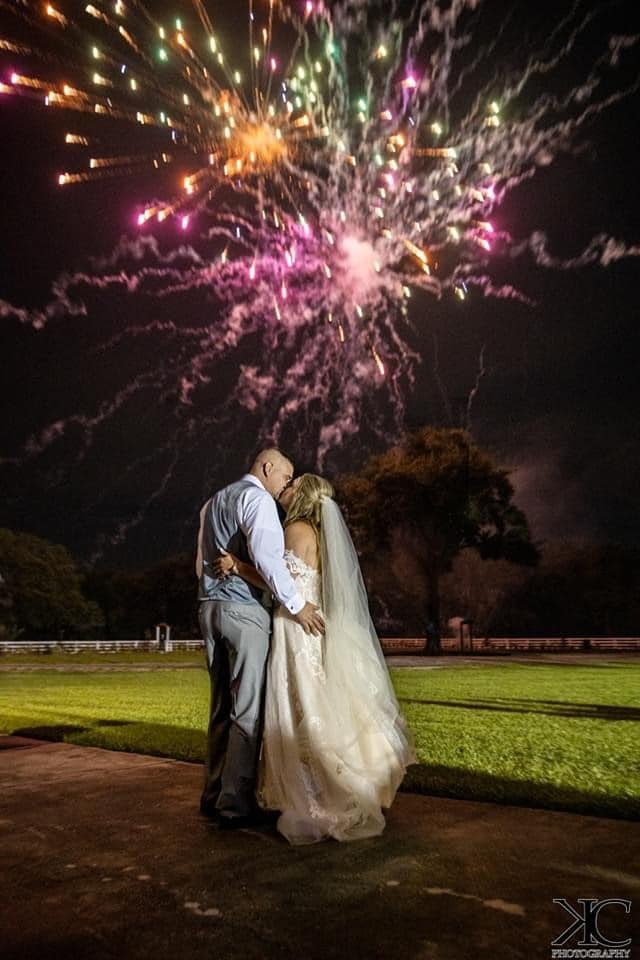 bride and groom kissing under fireworks at horsepower ranch wedding venue
